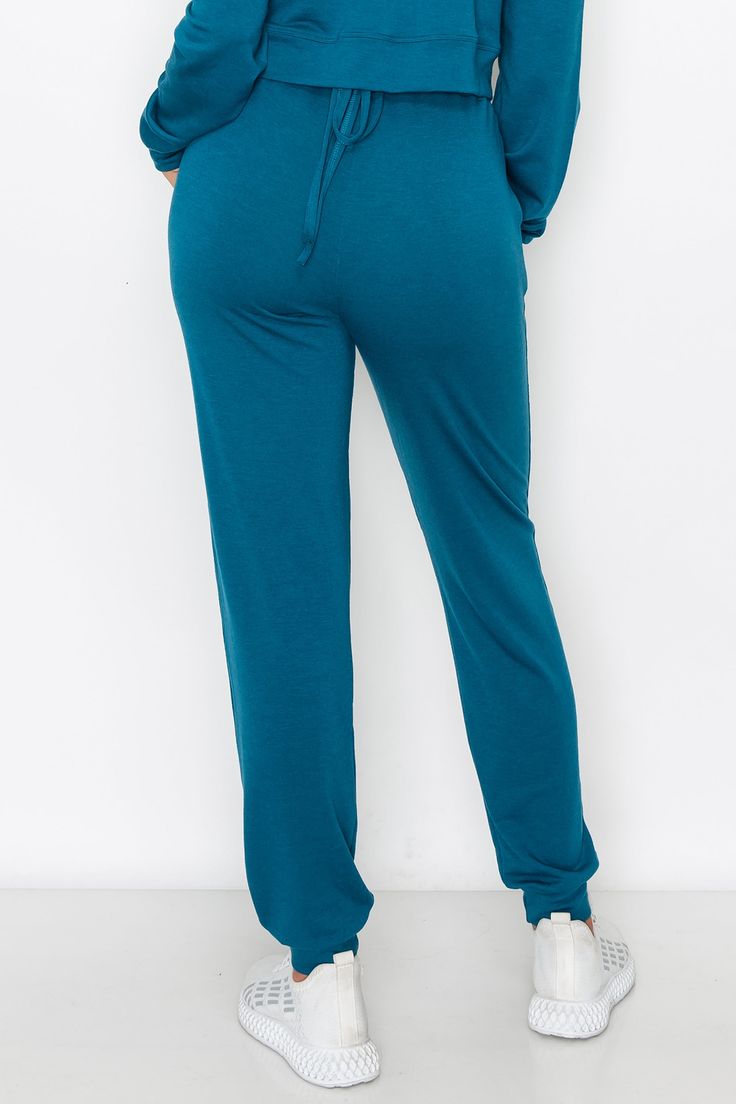 Made for active or relaxed days, these high rise relaxed joggers are the newest style added to our loungewear collection. Featuring a high-rise elasticized waistband with a drawstring detail, two pockets on each hip and cuffed hems, you’re going to love these full length loungewear joggers . High rise elasticized waistband Drawstring feature Two pockets on each hip Ultra-soft knit fabric with stretch 62% Polyester, 33% Rayon, 5% Spandex Imported Model StatsHEIGHT: 5'5" BUST: 32WAIST: 25.5HIPS: 3 Solid Color Drawstring Sweatpants For Loungewear, Drawstring Long Pants Activewear For Sports, Sports Activewear With Drawstring Long Pants, Comfy Leisure Activewear With Drawstring, Solid Color Sportswear Bottoms With Drawstring, Solid Sportswear Bottoms With Drawstring, Sportswear Joggers With Drawstring, Sportswear Bottoms With Drawstring For Leisure, Relaxed Fit Drawstring Sweatpants For Lounging