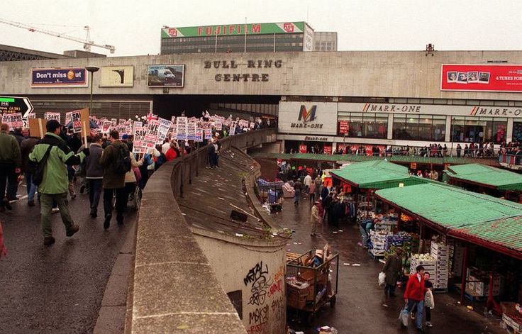 many people are walking down the street carrying signs