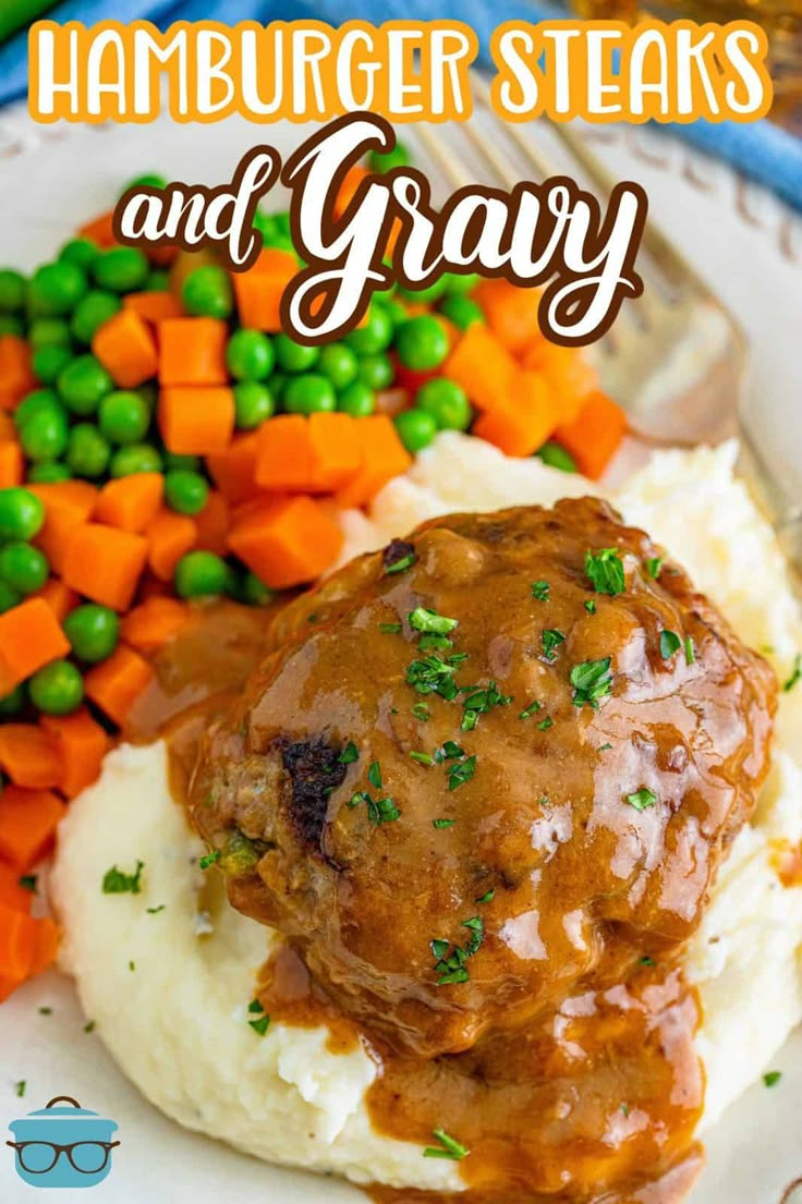 meat and gravy on mashed potatoes with peas, carrots and peas