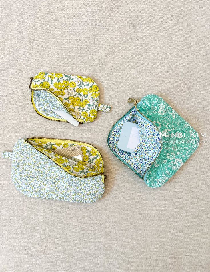 three small zippered pouches sitting next to each other