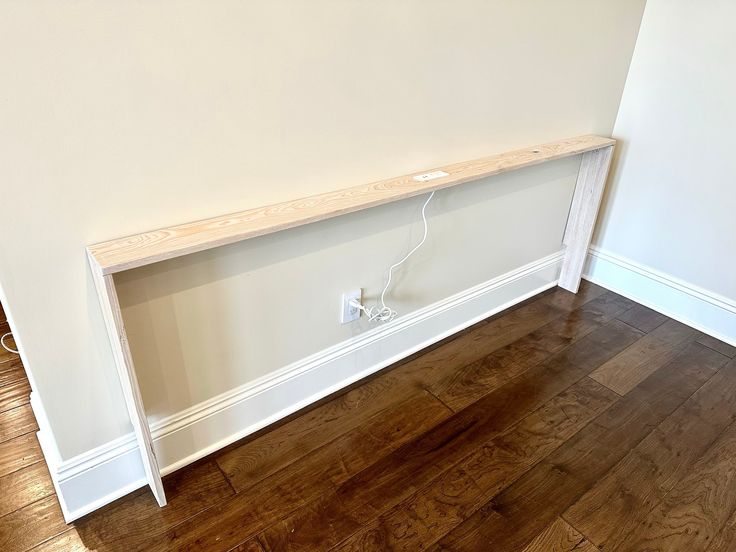 a white shelf sitting on top of a hard wood floor