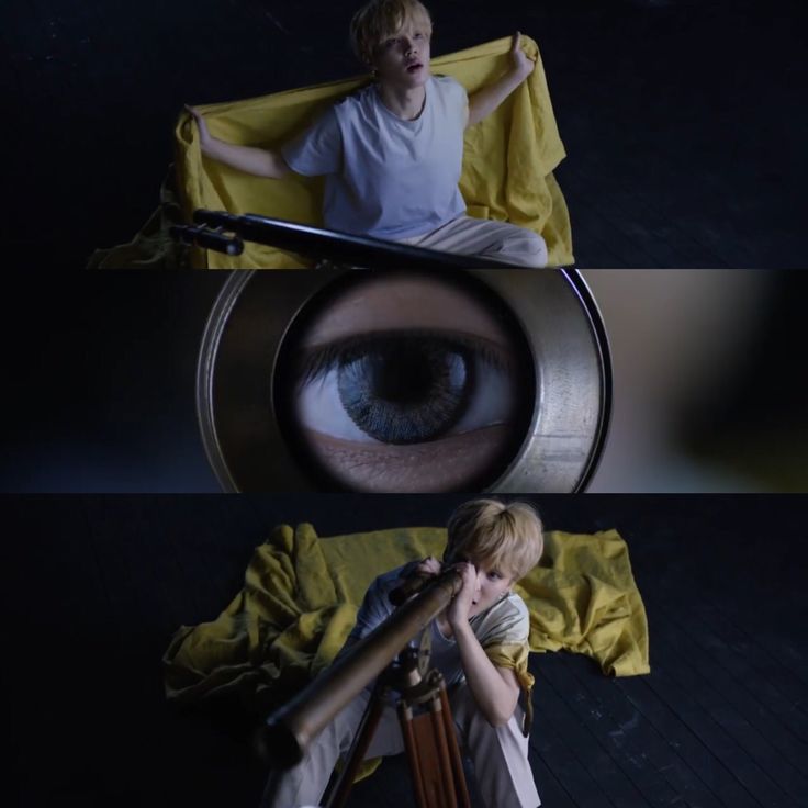 a boy looking through a magnifying glass at another person sitting on a chair