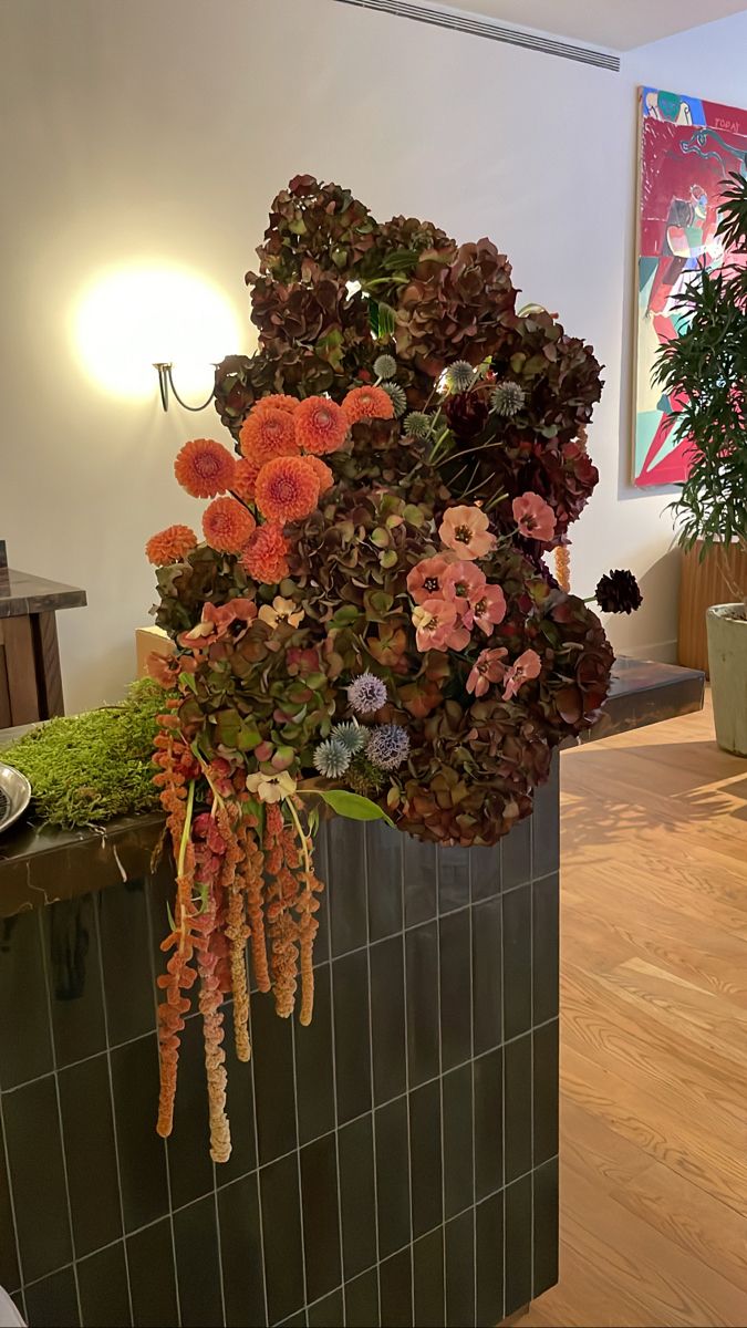 an arrangement of flowers on display in a room