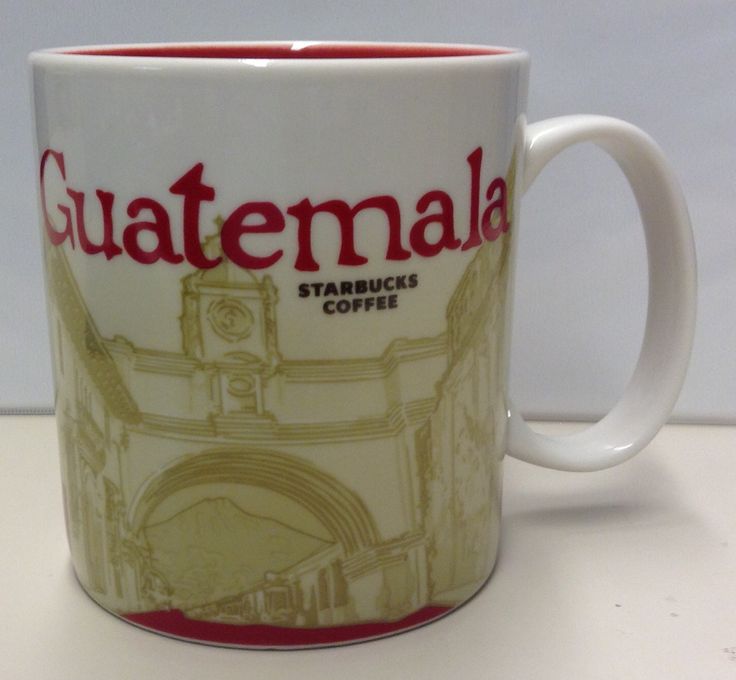 a coffee mug with the name guatemala on it and an image of a clock tower