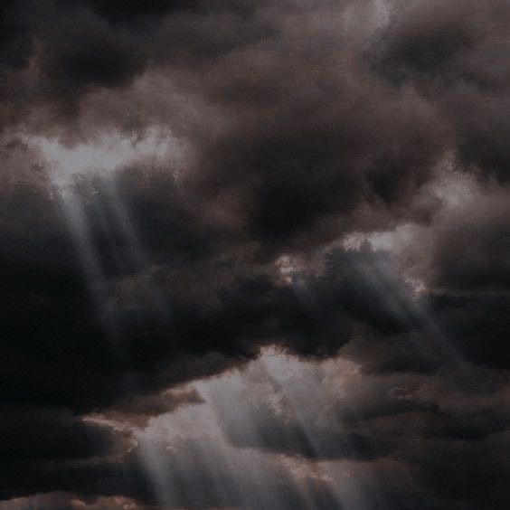 Mysterious Night Sky with Dark Clouds and Light Beams