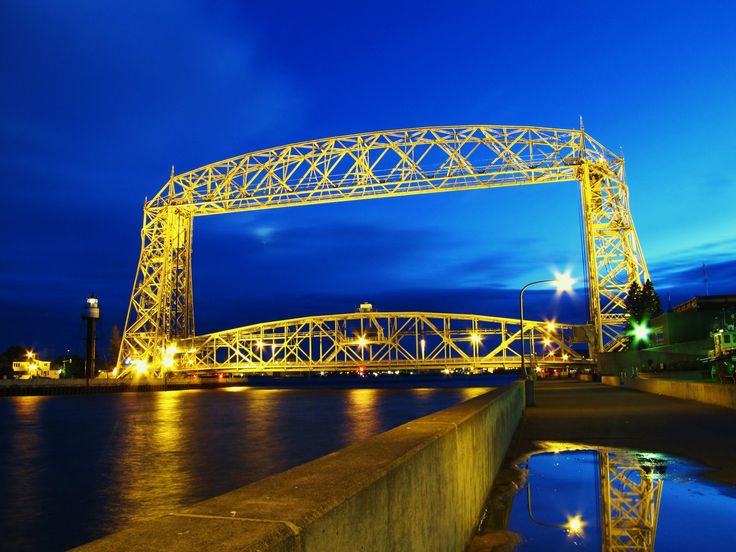 a bridge that is over some water at night