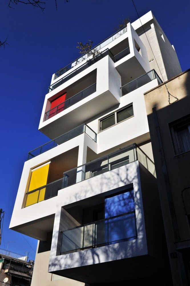 an apartment building with multicolored balconies and balconies