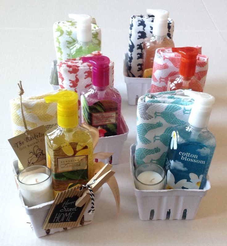 several different types of soaps and lotions in baskets on a white tablecloth