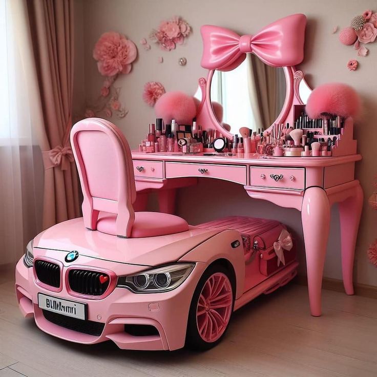 a pink car is parked in front of a desk with a mirror and makeup set on it