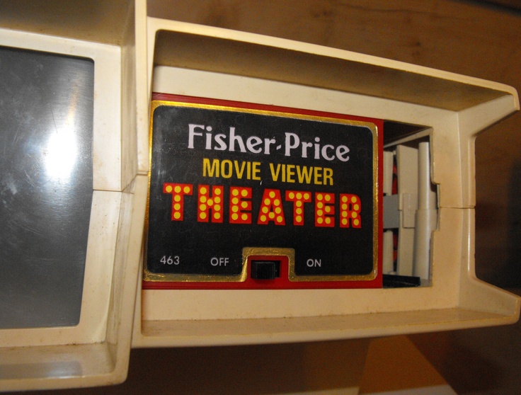 a close up of a microwave with a sign on the door that says fisher - price movie viewer theater