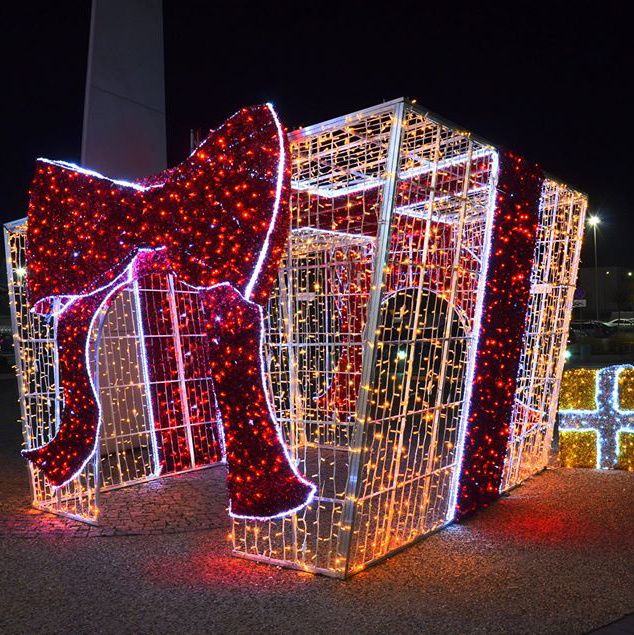 christmas lights are lit up in the shape of cubes with bows and bells on them