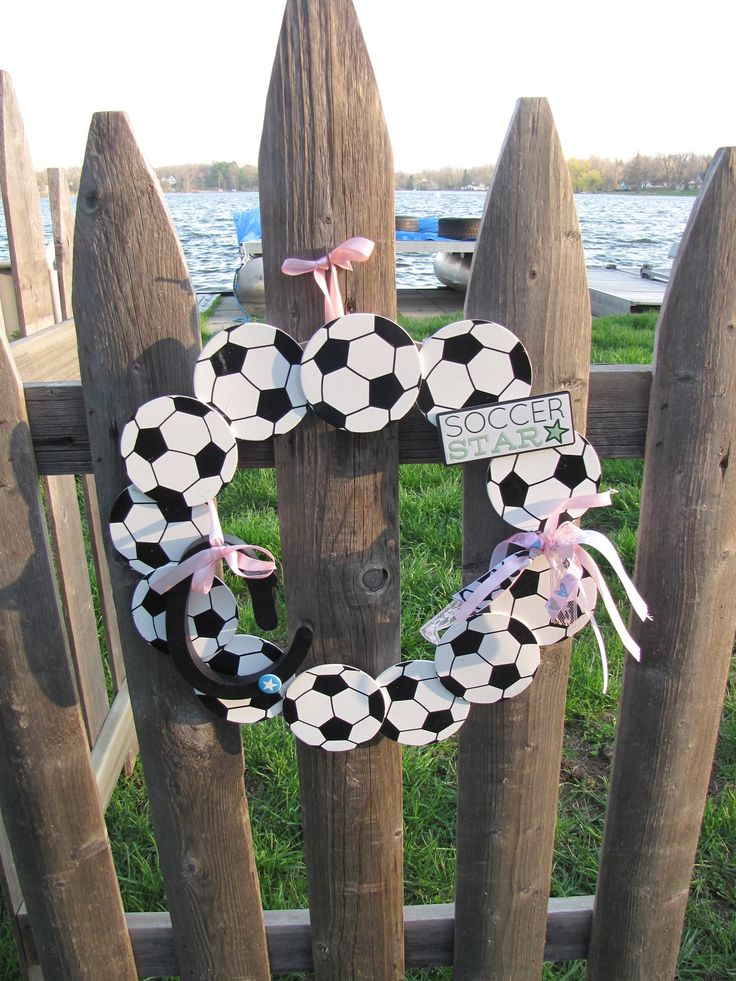 a soccer wreath is hanging on a fence