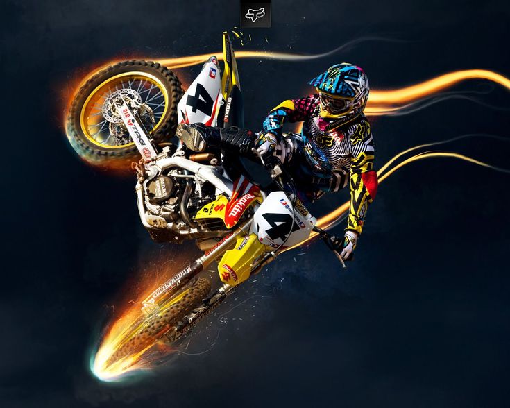 a person on a dirt bike in the air with flames coming out of their tires