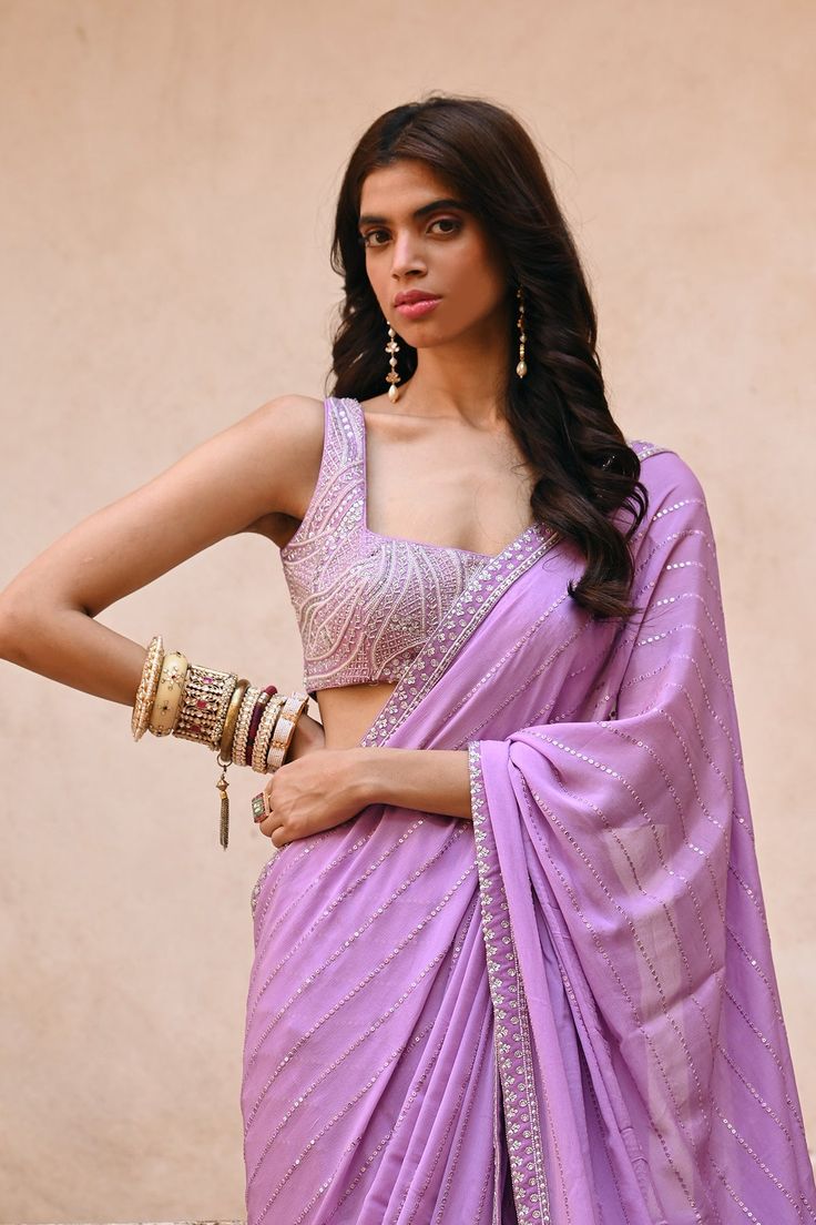 Zardozi and pearl blouse with georgette saree and peticoat FABRIC: Georgette, Raw silk COLOR: Lavender NO. OF COMPONENTS: 3 WASH CARE: Steam Iron, Petrol Wash CUSTOMIZATION AVAILABLE: YES DISCLAIMER: This Product is made to order. Product color may slightly vary due to photographic lighting sources or your computer setting. Latest Indian Saree Designs, Lilac Purple Saree, Lilac Saree Lavender, Lilac Silk Saree, Lavender Sari, Lavender Color Saree, Graduation Saree, Lilac Saree, Drape Sari