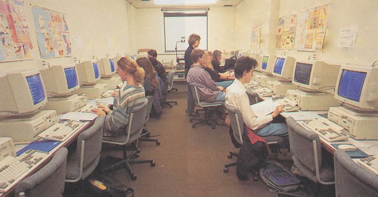 there are many people working on computers in this room