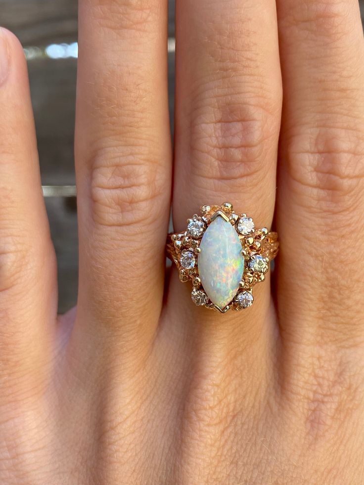 Total Weight: 8.2 grams Size: 5.75 Band Width: 2.4-17.8mm Opal: 16x6.6mm Diamonds: 2.2mm Condition: In great condition showing little wear with no damage. All gold has been thoroughly checked with an Olympus XRF spectrometer. It is guaranteed 14k gold.  All our jewelry is properly washed and disinfected to ensure customers get clean items with every order.  Returns accepted but may be subjected to a restock fee.  Please message with any questions:) White 14k Gold Cluster Jewelry, 14k Gold Marquise Cut Hallmarked Jewelry, Stamped 14k Gold Marquise Cut Jewelry, White Multi-stone Marquise Cut Jewelry, Collectible Cluster Fine Jewelry, White Marquise Halo Jewelry, White Marquise Cut Halo Jewelry, Fine Jewelry Multi-stone Marquise Cut, Fine Jewelry With Marquise Cut Multi-stone