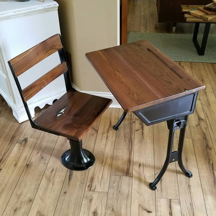 two wooden chairs sitting next to each other on top of a hard wood floor