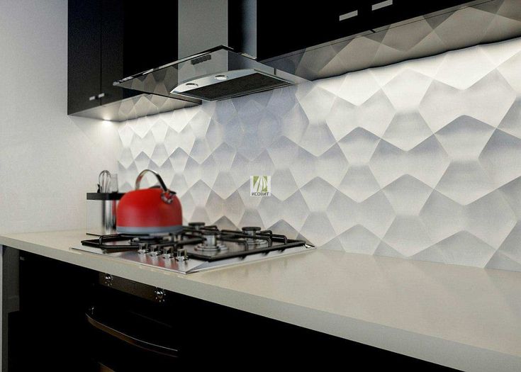 a red kettle sitting on top of a stove next to a wall covered in white paper