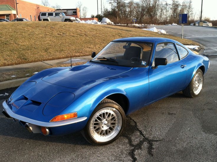 a blue sports car is parked on the street