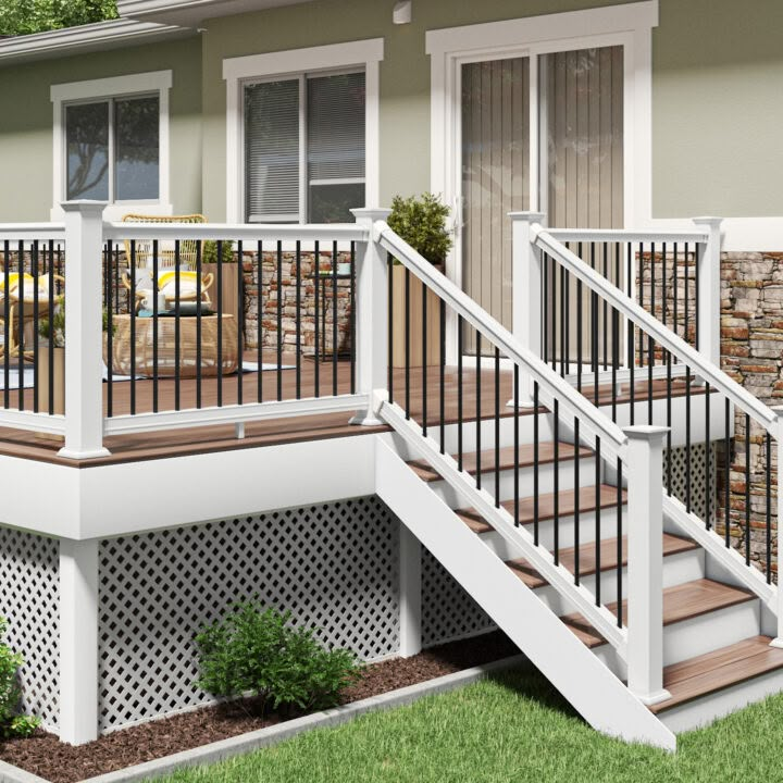 a house with white railings and wooden steps leading up to the front porch area