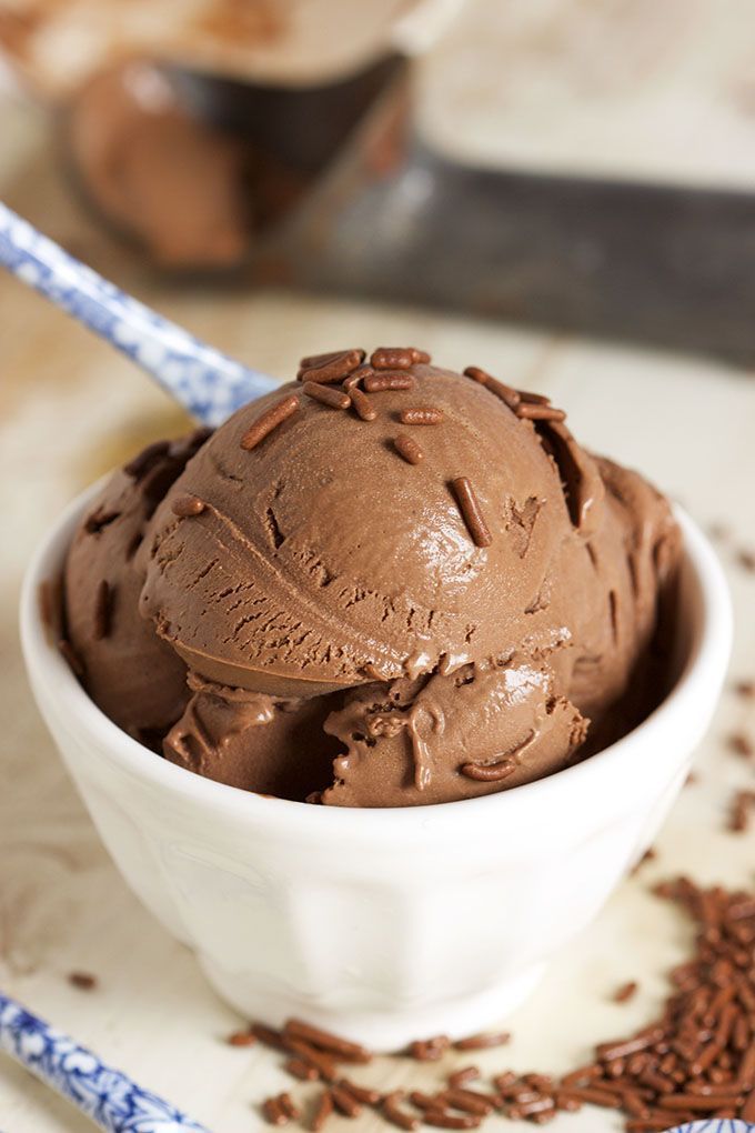 two bowls filled with chocolate ice cream on top of a wooden table