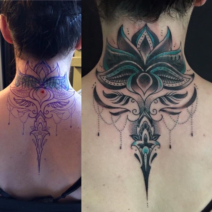 the back of a woman's neck is covered in intricate tattoos and beads,