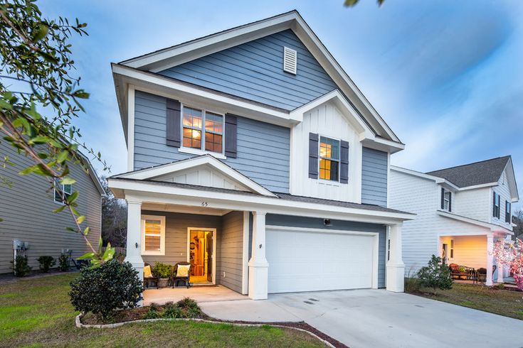 a two story house with blue siding and white trim