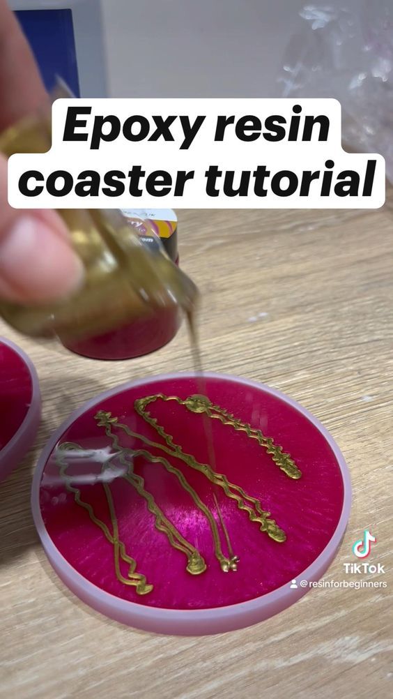 a person is pouring gold paint onto a pink object with the words epoxy resin coaster