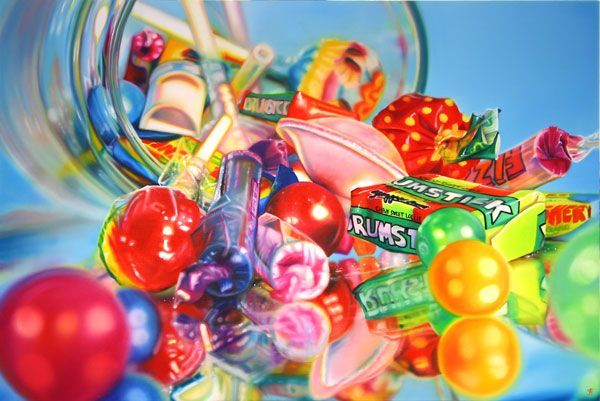 a jar filled with assorted candy and lollipops on top of a table