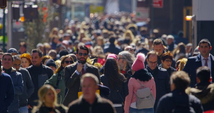 a large group of people walking down the street