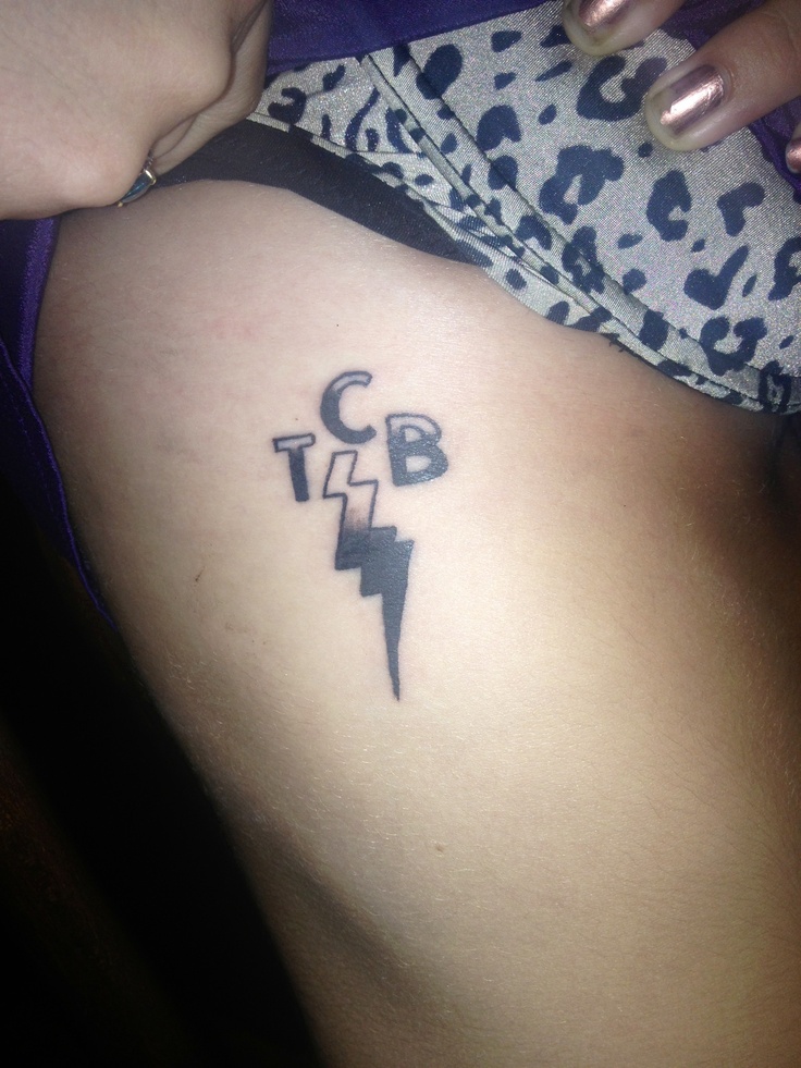 a woman with a tattoo on her stomach has a lightning bolt and the letter b