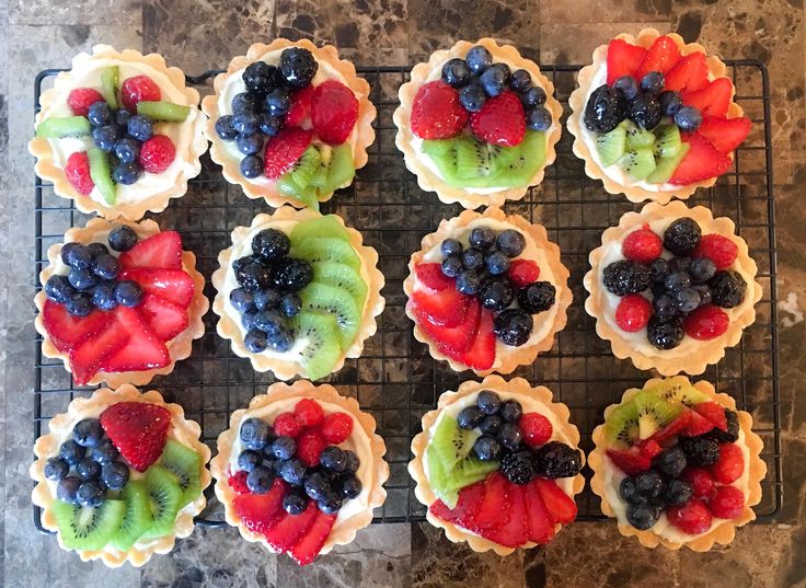 there are many cupcakes with fruit on them