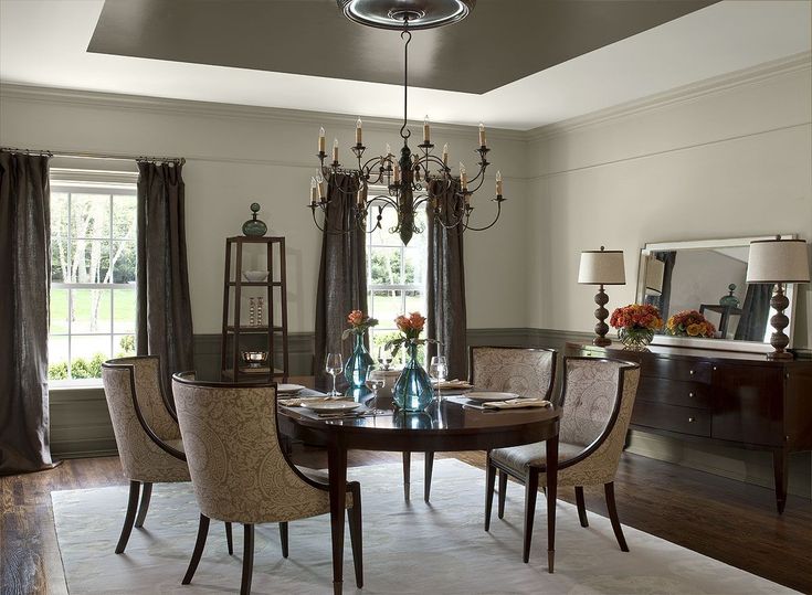 a dining room table with chairs and a chandelier