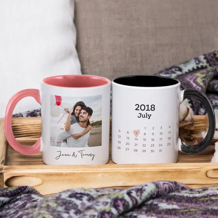 two personalized coffee mugs on a wooden tray