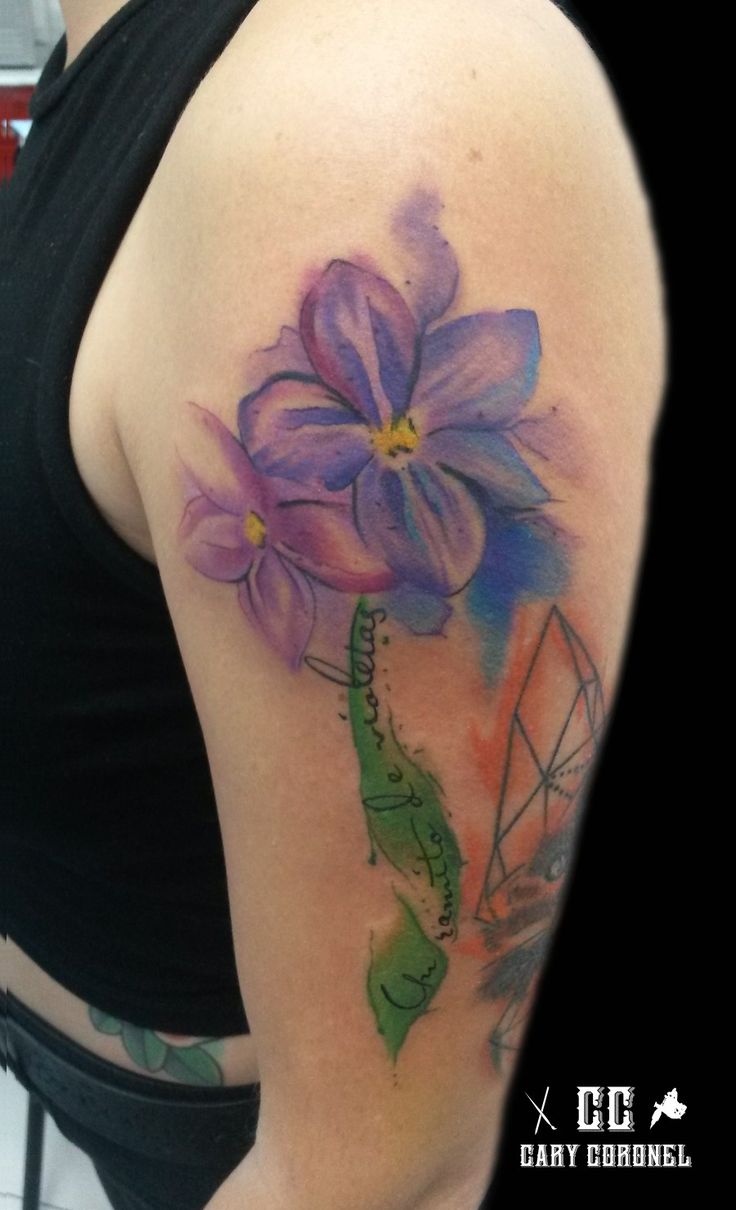 a woman with a tattoo on her arm and flowers in the middle of her arm