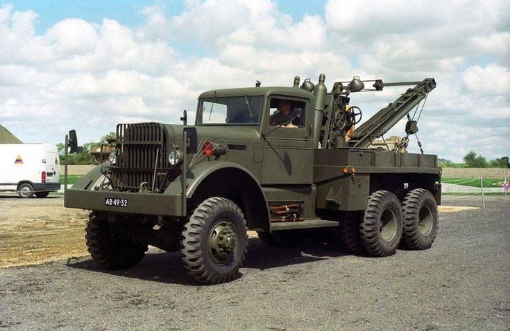 an army truck is parked on the side of the road