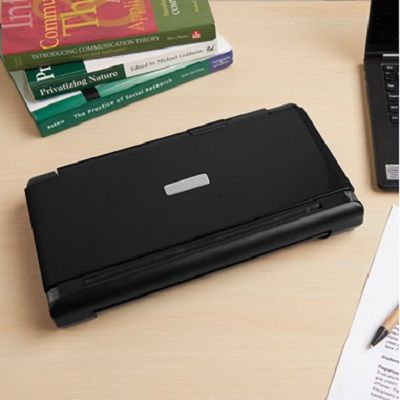 a laptop computer sitting on top of a wooden desk next to a pile of books