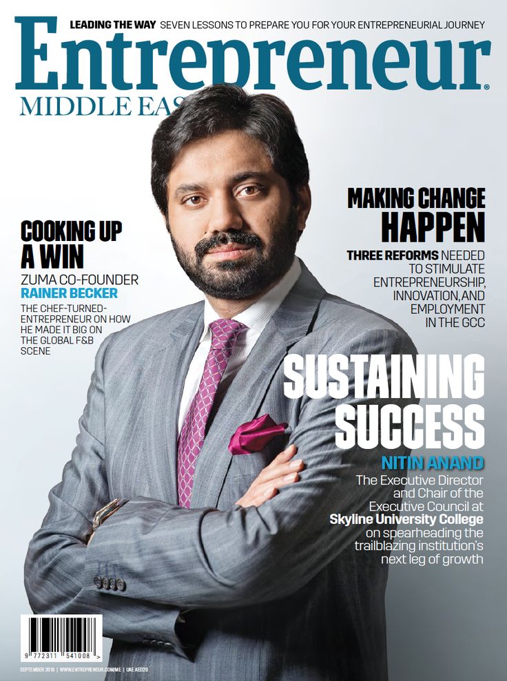 a man in a suit and tie on the cover of a magazine with his arms crossed