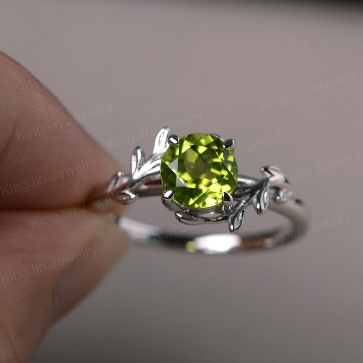 This is a gorgeous handmade creation, a combination of beauty, simplicity & Elegance. The 7*7mm round cut peridot is crafted in solid sterling silver and with rhodium plated. 14K white gold/rose gold/yellow gold available as well,pls contact me if you need. All item is sent in a beautiful gift box You can realize more lovely stuff clicking the link https://www.etsy.com/shop/knightjewelry?refshopsection_shophome_leftnav Please leave the correct address and you phone number for delivering succ Round Sapphire Engagement Ring, Vintage Inspired Wedding Band, Leaves Ring, August Birthstone Ring, Graduation Rings, Green Sapphire Engagement, Green Sapphire Engagement Ring, Green Sapphire Ring, Peridot Jewelry