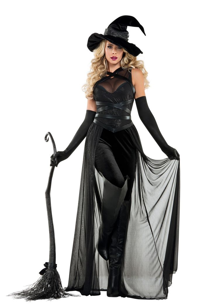 a woman dressed as a witch holding a broom and wearing a black dress with sheer fabric