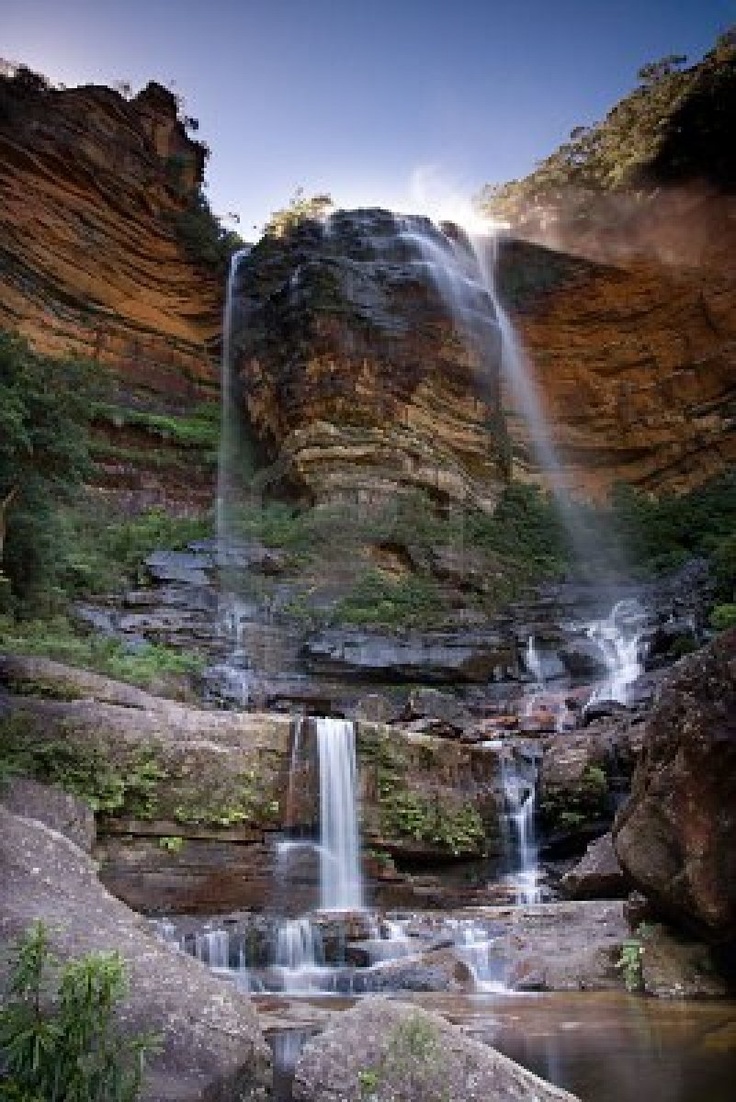 a waterfall is shown in the middle of some rocks