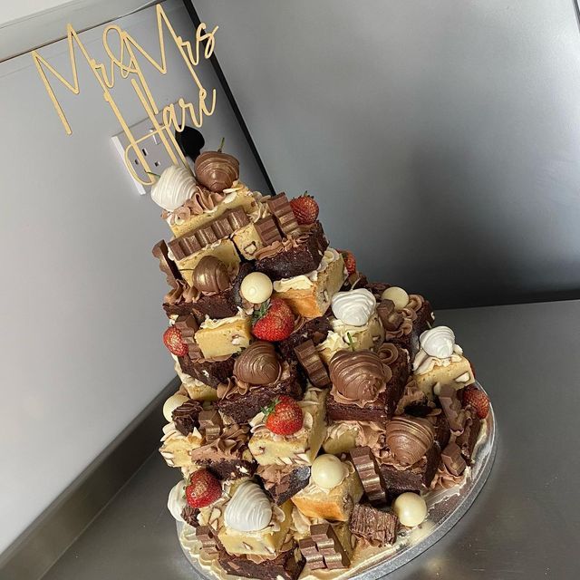 a cake made to look like a tower with chocolates and strawberries on top