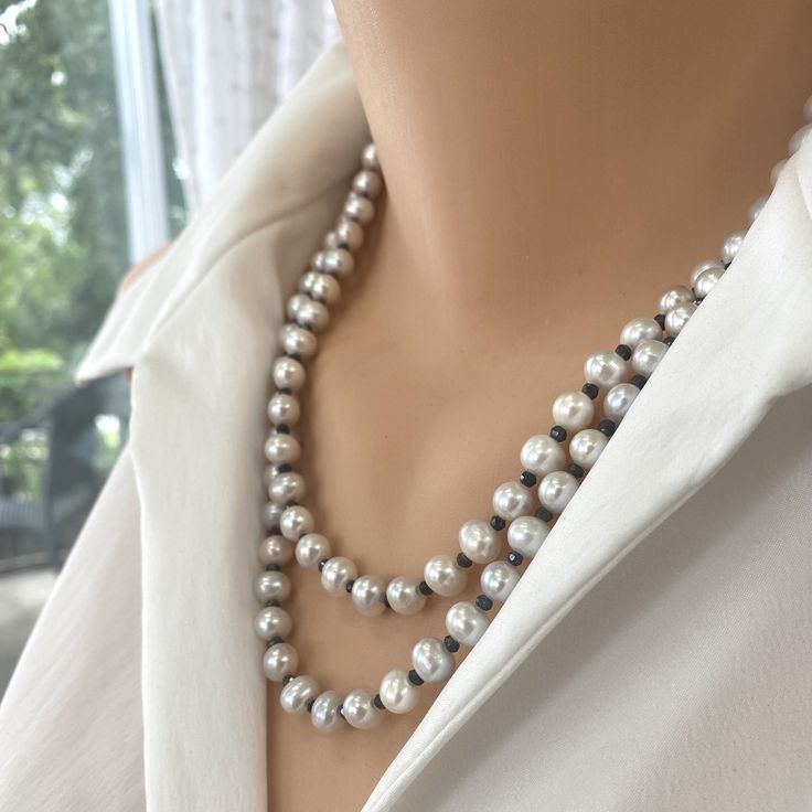 "This Light Grey Freshwater Pearls and Spinel Beaded Long Necklace with sterling silver details is a versatile and elegant accessory. Its combination of soft grey pearls and dark spinel beads creates a visually stunning piece of jewelry that can be worn for various occasions. Whether you wear it alone or layer it with other necklaces, this long necklace is sure to make a fashionable statement. MATERIALS: Very light silver freshwater pearls, 6-6.5x7-7.5-8mm Charcoal Spinel Beads 1.2mm Sterling silver clasp and 1\"inch chain extension This necklace is 41.5\"inches long including chain extension [105cm] All Loulia Pearl Jewelry orders are carefully packaged in a jewelry box with foam insert and secured with a ribbon for safe delivery. You will also get a beautiful jewelry pouch to store your Luxury Traditional Sterling Silver Beaded Necklace, Elegant Pearl Necklace For Layering With Round Beads, Elegant Pearl Necklace For Layering, Elegant Lariat Beaded Necklace For Layering, Elegant Faceted Beads Necklace For Layering, Silver Pearl Necklace With Faceted Beads, Silver Double Strand Beaded Necklaces For Layering, Silver Beaded Lariat Pearl Necklace, Classic Silver Beaded Necklace With Pearl Chain