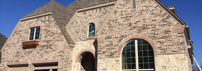 a large brick building with two arched windows