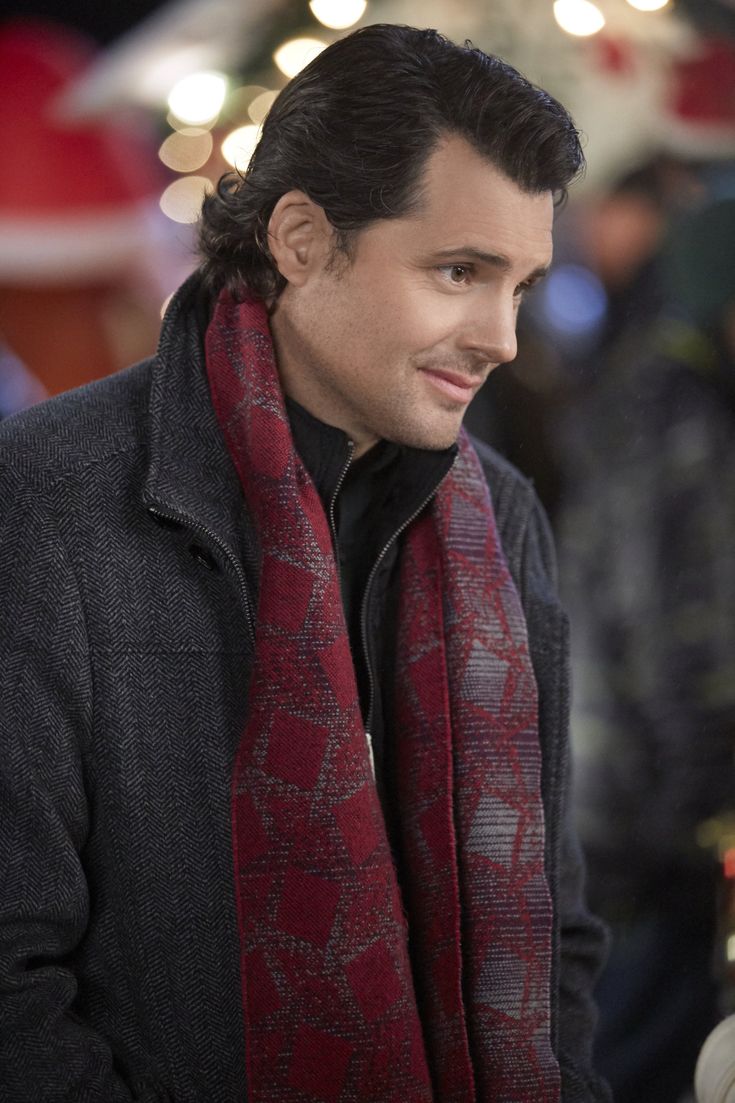 a man wearing a red and black scarf