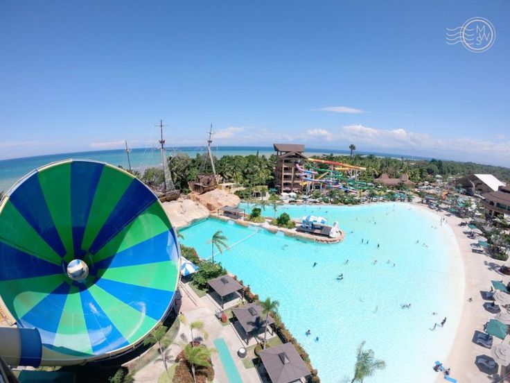 an aerial view of a water park with a large blue and green slide in the middle