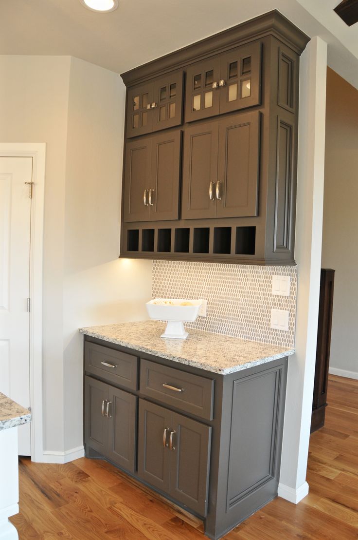 an empty kitchen with granite counter tops and cabinets on the wall, along with hardwood flooring