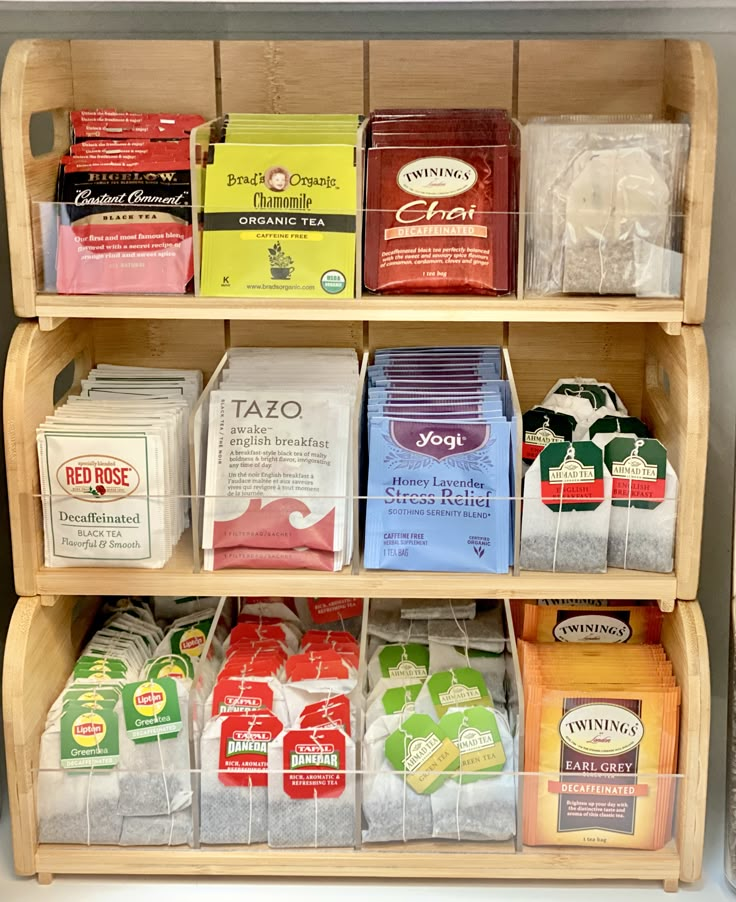 a shelf filled with lots of different types of teas and coffee bags next to each other