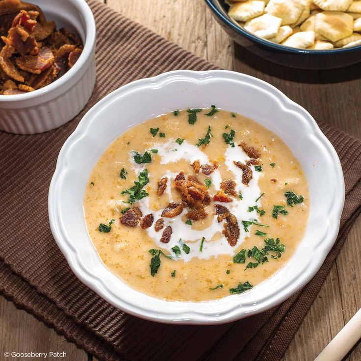 a white bowl filled with soup sitting on top of a table next to other dishes