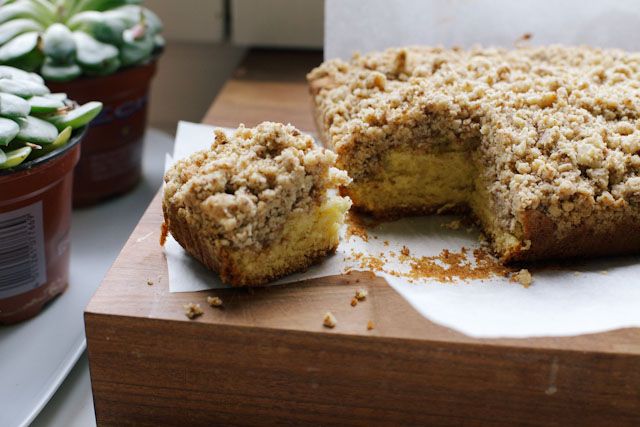 a cake that has been cut in half and is on a table next to some potted plants